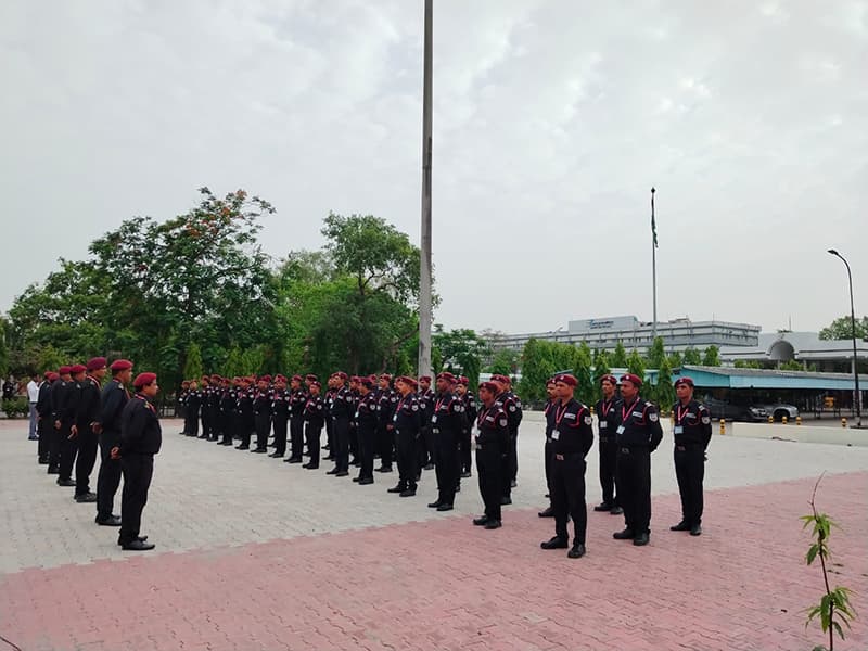 Omax recruits in red berets drilling in formation on a parade ground