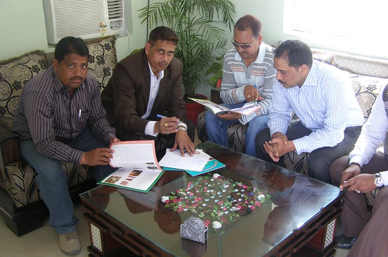 Omax managers in a planning meeting with a client
