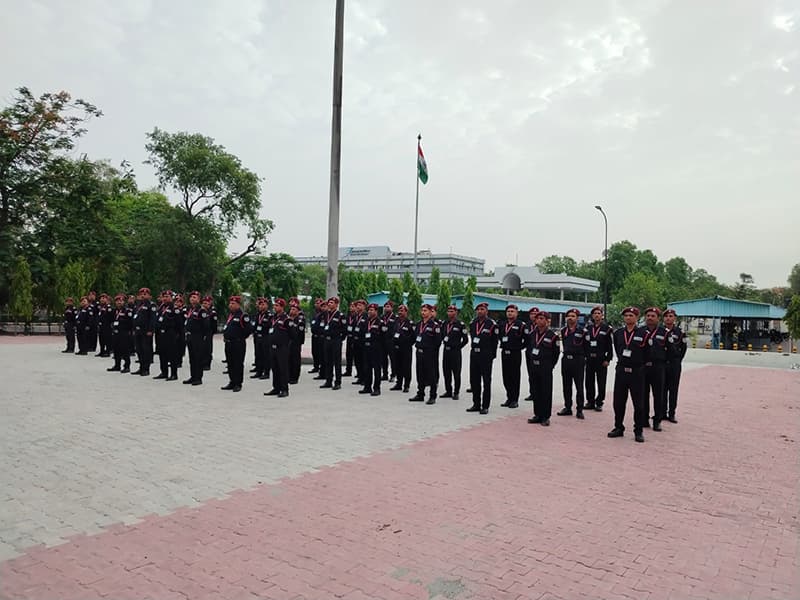 Omax recruits in red berets drilling in ranks on a parade ground